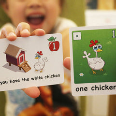 A child showing a card from Alana's animals game