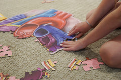 A Kid playing with the Human Heart Anatomy Puzzle